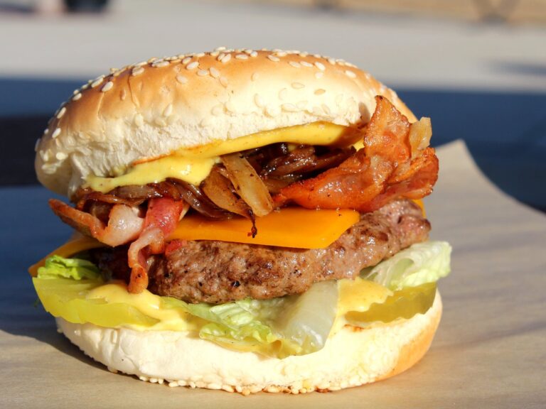 Mambo Havana Burger with bacon, cheese, grilled onions, lettuce, pickles, and sauce.