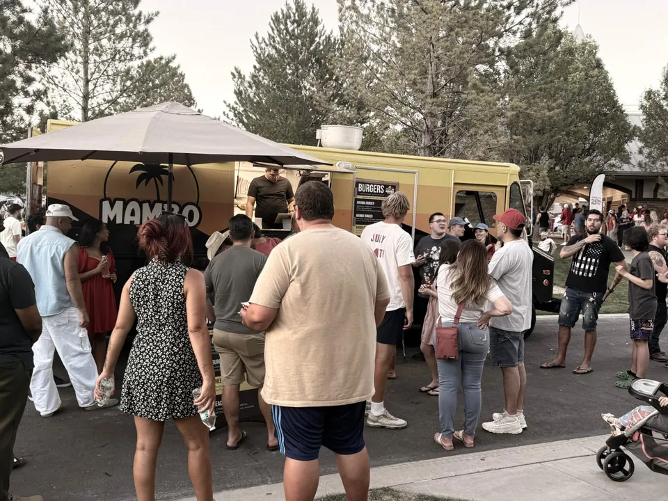Mambo food truck serving a large crowd at a real outdoor event.