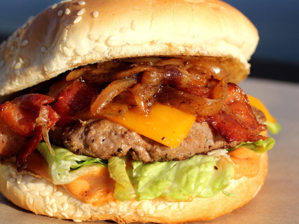 Mambo Burger with cheddar cheese, smoked bacon, caramelized onions, lettuce, and Mambo Fry Sauce.